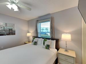 a bedroom with a white bed and a window at Beachside Villas #413 in Seagrove Beach +21 photos