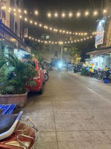 a car parked in a parking lot with lights at Hotel Grants Residency Colaba in Mumbai