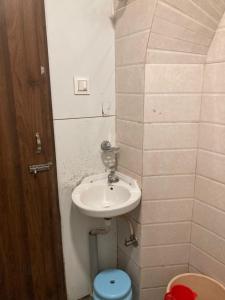 a bathroom with a sink and a toilet at Hotel Grants Residency Colaba in Mumbai