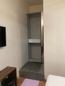 a room with a closet with a shelf in it at Hotel Grants Residency Colaba in Mumbai +7 photos