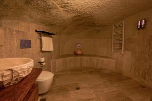 a bathroom with a sink and a tub and a toilet at Babili Cappadocia Cave in Nevşehir +95 photos
