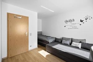 a living room with a couch and a bed at Moderne Einraumwohnung in Leipzig mit Netflix Zugang in Leipzig