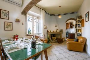 a living room with a glass table and a living room at Giaminera Rooms & Art Studio in Baunei