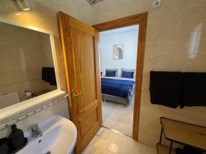 a bathroom with a sink and a bedroom with a bed at Casa Indigo Mazarron in Mazarrón