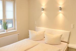a bedroom with two white pillows on a bed at Quartier Spreestraße - App 3 in Burg