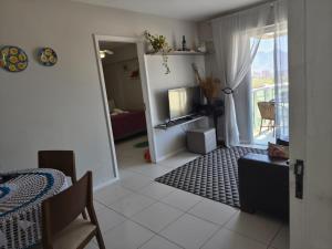 a living room with a television and a room with a balcony at Rio Stay Suíte in Rio de Janeiro +14 photos