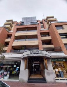 a tallartment building with a store in front of it at Departamento CBA in Córdoba +2 photos