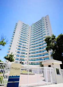 a large white building with a white gate in front of it at Rio Stay Suíte in Rio de Janeiro