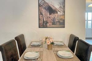 a dining room table with chairs and a picture on the wall at Blockhaus Baum 3 in Burg