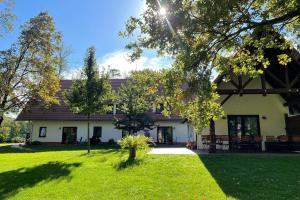 a large white house with a green yard at Blockhaus Baum 3 in Burg +24 photos