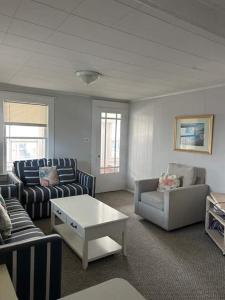 a living room with two couches and a coffee table at OCHG 306 Talbot Top in Ocean City