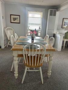 a dining room with a wooden table and chairs at OCHG 306 Talbot Top in Ocean City