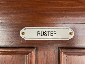 a sign on a wooden door that reads rustler at Altstadtflair - Rüster in Lübbenau +7 photos