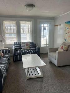 a living room with couches and a coffee table at OCHG 306 Talbot in Ocean City