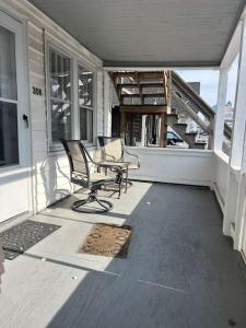 a porch with two chairs and a table on a house at OCHG 306 Talbot in Ocean City