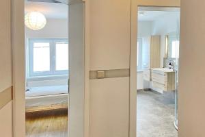 a bathroom with a door leading into a room at Libelle in Lübben