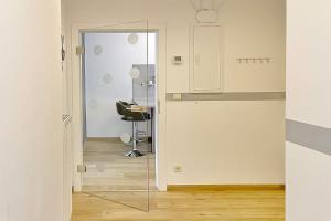 a glass door leading into a room with a chair at Libelle in Lübben +17 photos