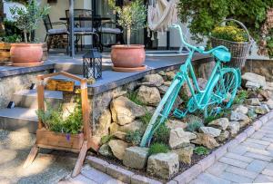 a blue bike parked on a stone wall at Jázmin Chill Cottage in Bánk