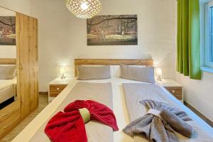 a bedroom with a bed with two towels on it at Holzfäller Baum 2 in Burg +11 photos