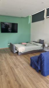 a bedroom with two beds and a wooden floor at L'Oasi Amena - Loft in Ameno