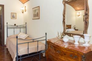 a bedroom with a bed and a mirror on a dresser at Casa del Grande Vecchio 2 in Airasca