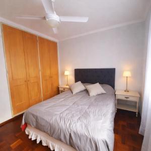 a bedroom with a large bed with two night stands at Departamento CBA in Córdoba