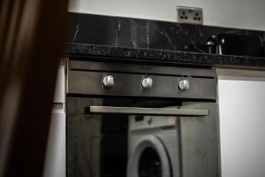 a kitchen with an oven with a counter top at Private Studio Apartment · Quiet · Sleeps 2 in Nottingham +7 photos