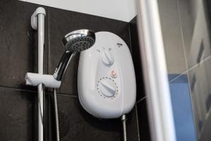 a hair dryer is hanging on a wall at Private Studio Apartment · Quiet · Sleeps 2 in Nottingham