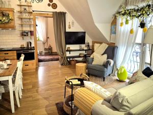 a living room with a couch and a table at Apartament U Moniki, nad rzeką, jacuzzi w ogrodzie in Szaflary