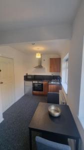 a kitchen with a table with a bowl on top of it at Cosy Studio · Easy City Access · Nottingham in Nottingham