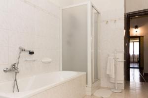 a white bathroom with a tub and a shower at Casa del Grande Vecchio 2 in Airasca +34 photos
