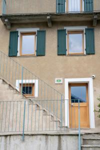 a staircase leading up to a building with green shutters at Casa Gemma in Rimella
