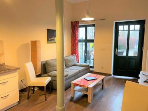 a living room with a couch and a table at Malz in Lübbenau