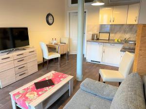 a living room with a couch and a table and a kitchen at Malz in Lübbenau