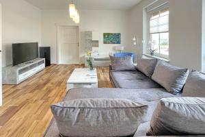 a living room with a couch and a tv at Malve in Lübbenau