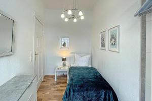 a small bedroom with a bed and a table at Malve in Lübbenau +9 photos