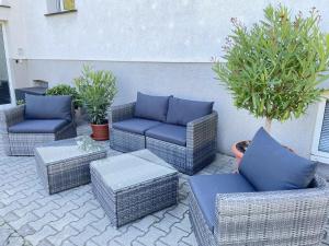 a group of wicker chairs and tables on a patio at Malve in Lübbenau