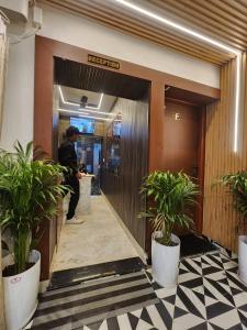 a man standing at a counter in a hotel lobby at The Trishul Stay in Varanasi