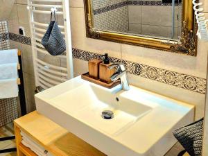 a bathroom with a white sink and a mirror at Apartament U Moniki, nad rzeką, jacuzzi w ogrodzie in Szaflary +25 photos