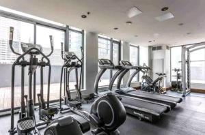 a gym with several treadmills and elliptical machines at The Alpine City Escape in Calgary