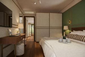 a bedroom with a large bed and a desk and a bed at MarePineta Resort in Milano Marittima +109 photos