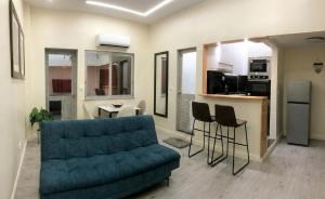 a living room with a couch and a kitchen at Mutamba Prime Stay in Luanda +19 photos