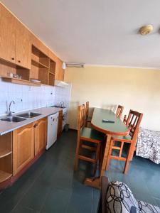 a kitchen with a table and chairs and a bed at Apart Hotel Alem in Ushuaia