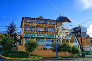a building with a sign in front of it at Apart Hotel Alem in Ushuaia