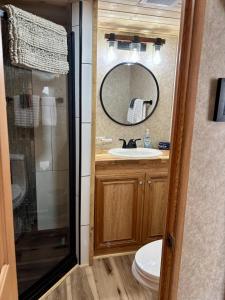 a bathroom with a sink and a mirror at Maggie Valley Cabin Rentals in Maggie Valley