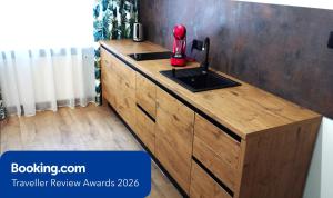 a kitchen with a wooden counter with a red blender on it at Through the Art Gallery in Piła
