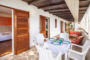 a dining room with a table and white chairs at Terrazza sul Mare Case Vacanze in Capo Rizzuto