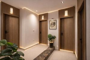 a hallway with doors and plants in a building at TAJ Suites Pyramids View Hotel in Cairo