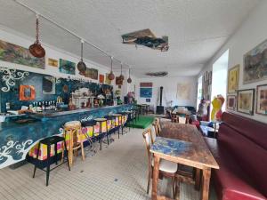 a room with a bar with a table and chairs at L'Art de l'Être in Saint-Vincent-de-Reins
