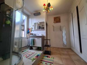a small kitchen with a sink and a chandelier at L'Art de l'Être in Saint-Vincent-de-Reins